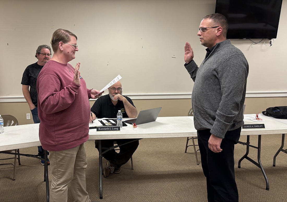 Milford Clerk-Treasurer Tricia Gall swore in new Deputy Marshal Matthew Wynn Monday evening. Photo by Denise Fedorow