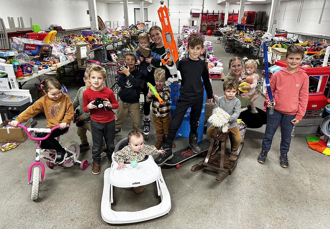 Volunteers and children pose with some of the gently used toys that are part of the Combined Community Services Toy Time consignment sale and giveaway. The toy sale is 9 a.m. to 7 p.m. Saturday and 9 a.m. to 3 p.m. Sunday.  Photo by David Slone, Times-Union