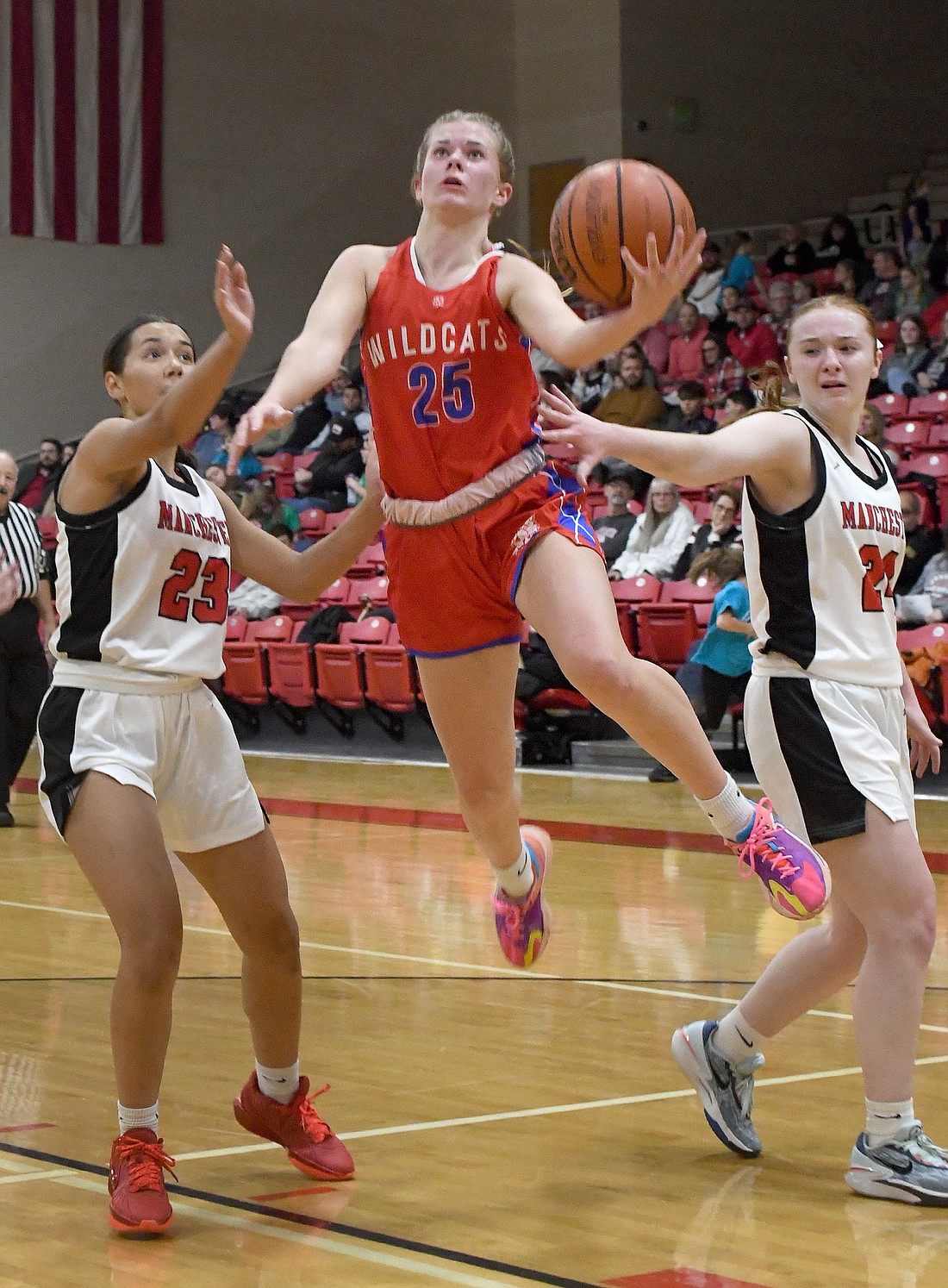 Whitko junior Reese Stonebraker splits between Manchester defenders Hadley West (L) and Emma Walker...NIeter