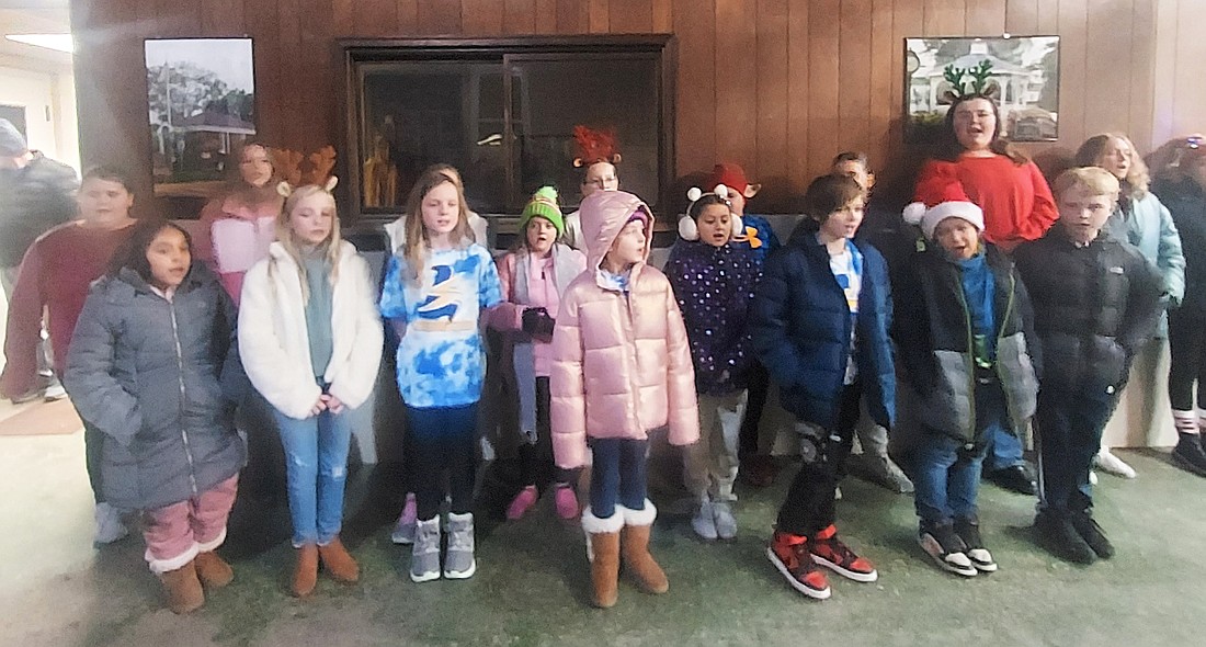 Students from Leesburg Elementary School sang Christmas carols during Leesburg’s Christmas party Saturday in the old fire station. Photo by Jackie Gorski, Times-Union.