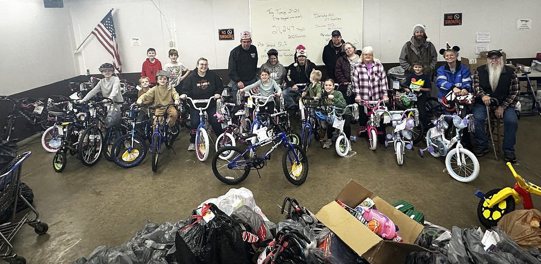 American Bikers Aimed Toward Education (ABATE) poses Monday with Combined Community Services Toy Time volunteers and the 43 bicycles and toys that ABATE provided for the new toy giveaway. Photo by David Slone, Times-Union