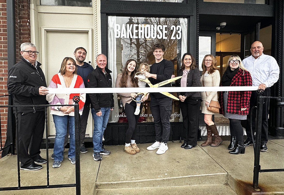 Kaley and Devin Dawson, owners of Bakehouse 23, 108 N. Buffalo St., Warsaw, cut the ribbon for the ribbon-cutting ceremony with the Kosciusko Chamber of Commerce. Photo by David Slone, Times-Union