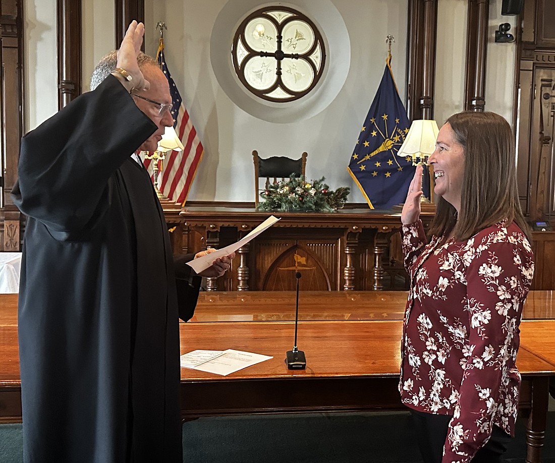 Circuit Court Judge Mike Reed (L) gives new County Clerk Melissa Boggs the oath of office Tuesday. Photo by David Slone, Times-Union