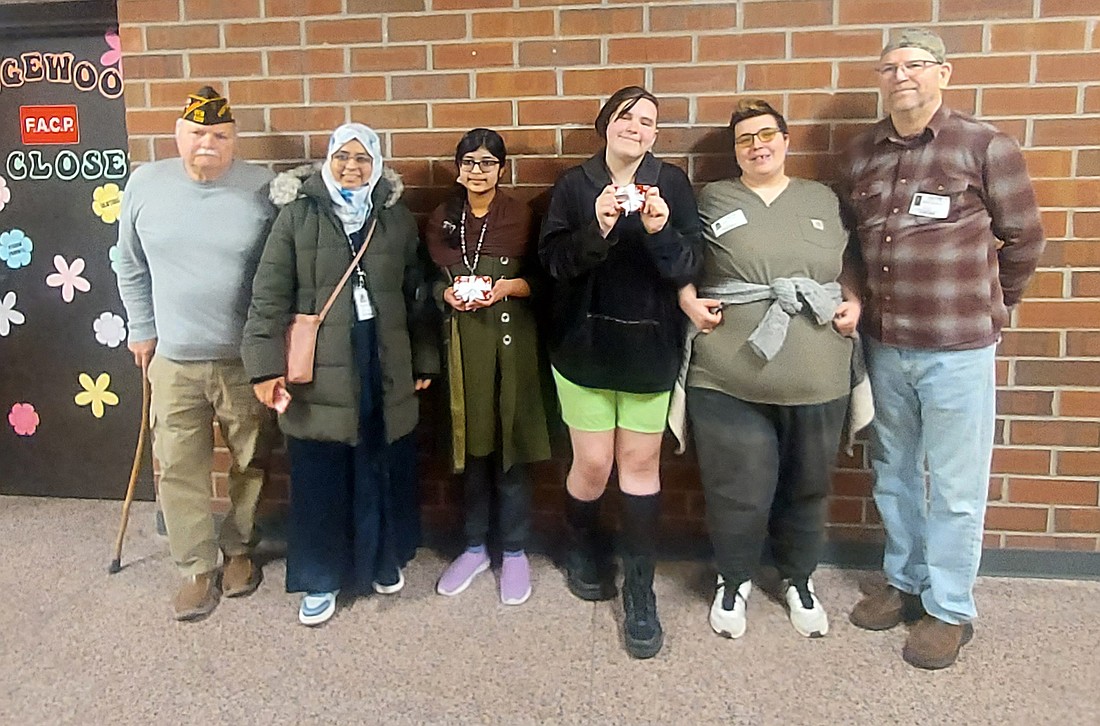 Pictured (L to R) are Dave White, VFW Post 1126 quartermaster; Juveria Azher, Maryam Anwar, Liam Everett, Lauren Everett and Robert Dockery, VFW Post 1126 community service representative. Photo by Jackie Gorski, Times-Union