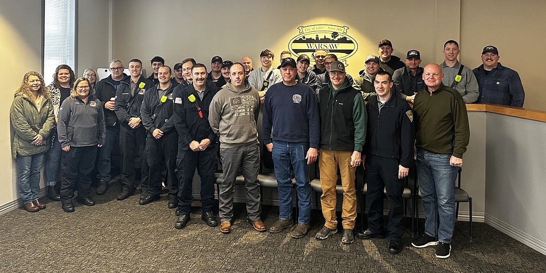 Three city employees with a total of 65 years of service were recognized at the Warsaw Board of Public Works and Safety meeting Friday, though only one was able to attend the meeting. Josh Engler (front right, fourth from right) has been with the Warsaw-Wayne Fire Territory for 20 years. Other service anniversaries include Robert Marshall, wastewater treatment utility, 25 years; and Jeremy Skinner, community and economic development director, 20 years. Photo by David Slone, Times-Union