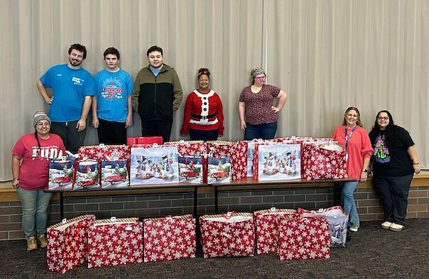 Boomerang Backpacks are prepared at Whitko Career Academy by the Functional Skills class members for distribution to Pierceton Elementary School students. In January students at South Whitley Elementary and Whitko Junior Senior High School will have access to the backpacks, too. Pausing after a day of backpack filling (L to R) are Functional Skills aide Kayla Studebaker; class members Zach Allen, Andrew Bowman, Kevin Prieto-Lopez, Sarah Brandenburg and Tessa Eiler; Stephanie Meyer, RN, Whitko's corporation nurse; and Functional Skills aide Heather Orbeck. Photo Provided