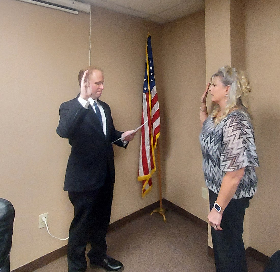 Austin Rovenstine (L), secretary for the Kosciusko County Republican Party Central Committee, swears in Ann Wiesehan as the Franklin Township trustee. Photo by Jackie Gorski, Times-Union