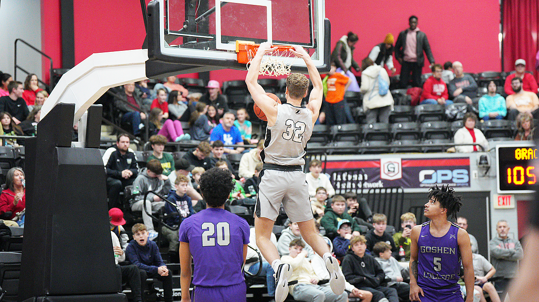 Pictured is Cole Hayworth with a late slam dunk during Grace's win over Goshen on Saturday