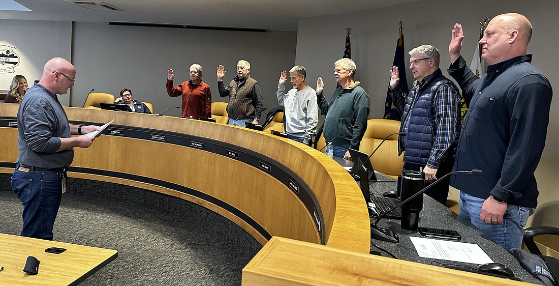 Warsaw Mayor Jeff Grose (L) gives the oath of office Monday to Warsaw Redevelopment Commission members (L to R, standing) George Clemens, Mike Klondaris, Bill Curl, Jack Wilhite, Joe Thallemer and Brad Johnson. Clemens was re-elected by the commission as president for 2025, with Klondaris as vice president and Curl as secretary. Photo by David Slone, Times-Union