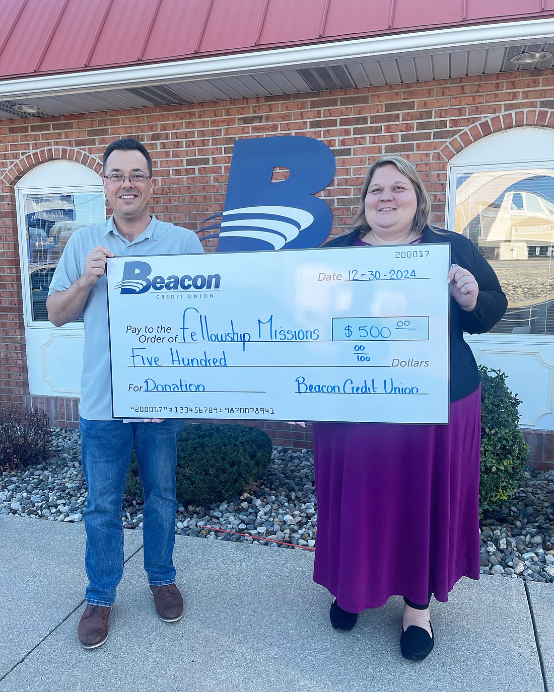 Pictured (L to R) are Eric Lane, executive director of Fellowship Ministries, and Christine Miller, Beacon Credit Union Warsaw Member Center manager. Photo Provided.