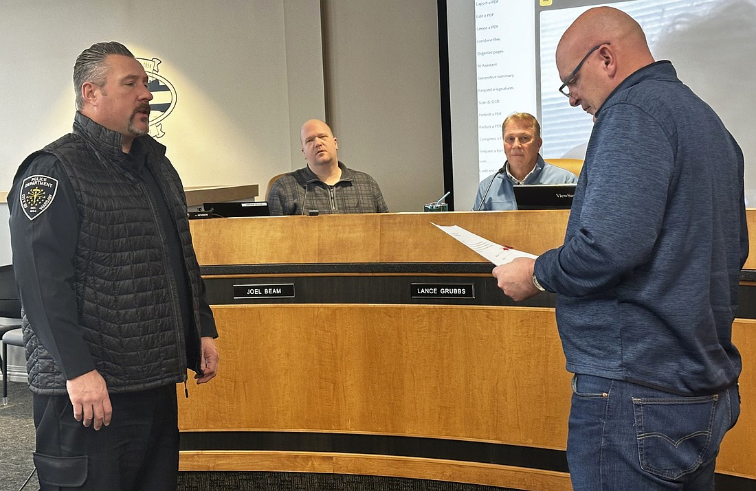 Warsaw Mayor Jeff Grose (R) on Wednesday swears in new Warsaw Traffic Safety Commission member Brad Kellar (L), Warsaw Police Department Patrol division captain. Looking on (in back) are (L to R) WPD Capt. Joel Beam and Traffic Administrator Lance Grubbs. Photo by David Slone, Times-Union.