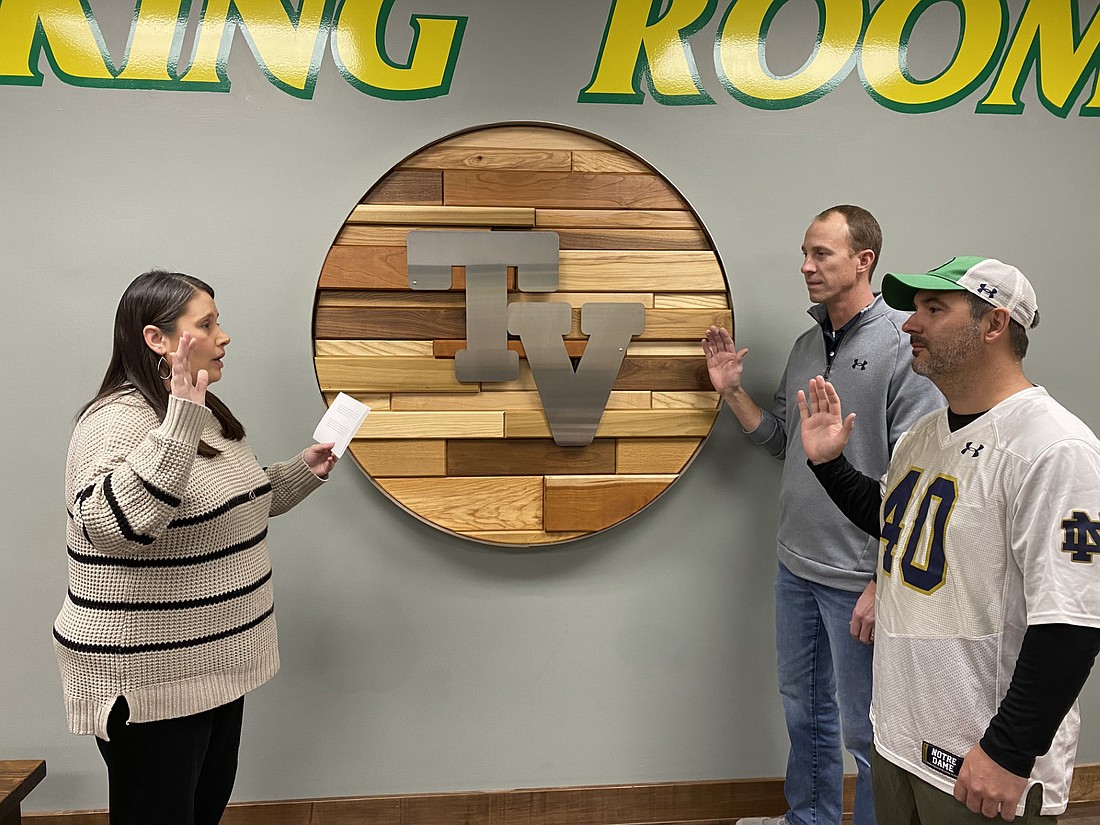 Tippecanoe Valley School Corp. Deputy Treasurer Melinda Kamp (L) swears in Adam Heckaman (C) and Aaron Zolman as Tippecanoe Valley School Board members at a special meeting on Thursday at Tippecanoe Valley High School. The two won reelection to their seats in 2024. Photo by Leah Sander, InkFreeNews