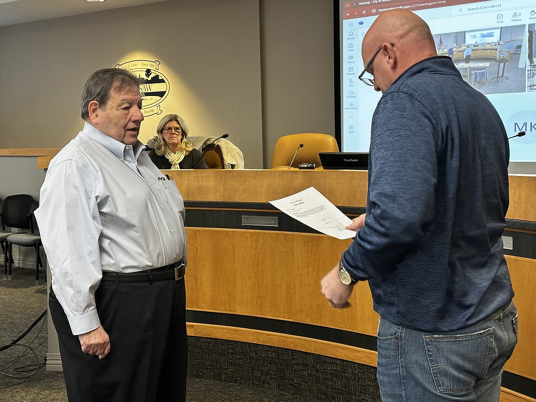 Warsaw Mayor Jeff Grose (R) gives the oath of office to Steven Smilay for the Board of Aviation Commissioners. Smilay replaces Jay Rigdon, who retired from the board in December after 35 years. Photo by David Slone, Times-Union