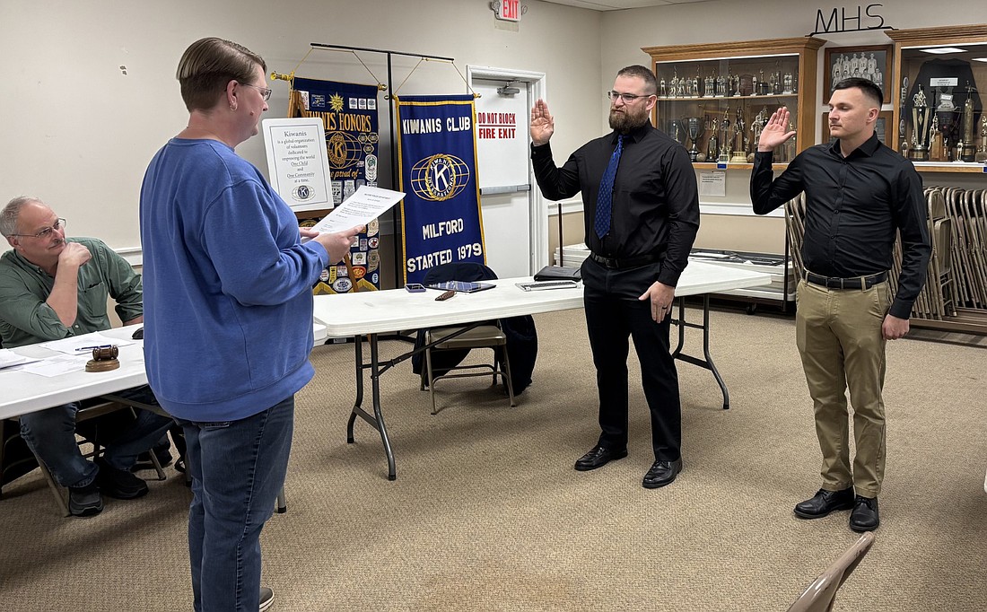 Milford Clerk-Treasurer Tricia Gall swears in new police reserve officers Dallas Rice (L) and Devon Valentine (R) Monday. Council President Doug Ruch looks on. Photo by Denise Fedorow