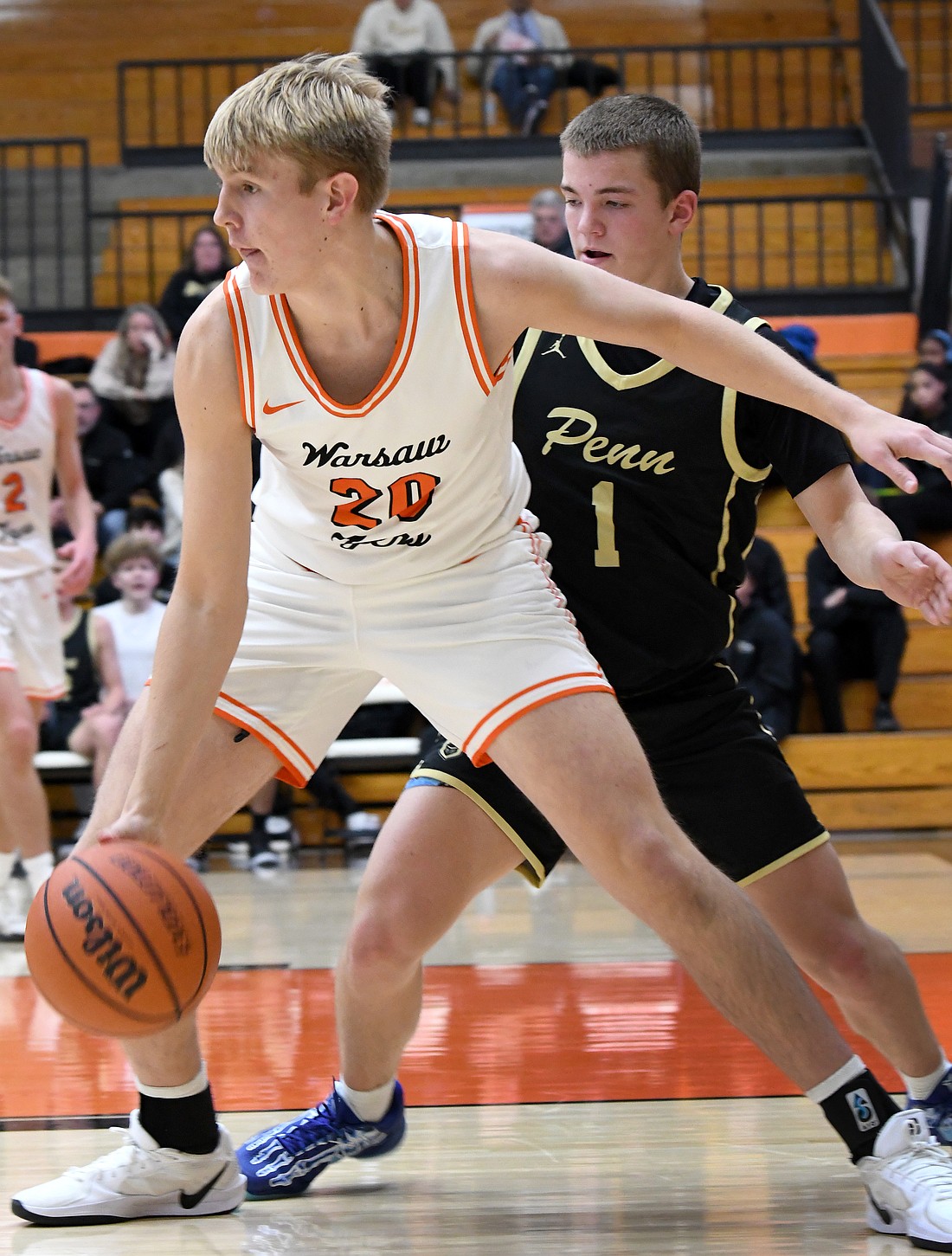 Warsaw senior Parker Justice works against Benjamin Murphy of Penn during the second quarter of Tuesday night's home game...Nieter