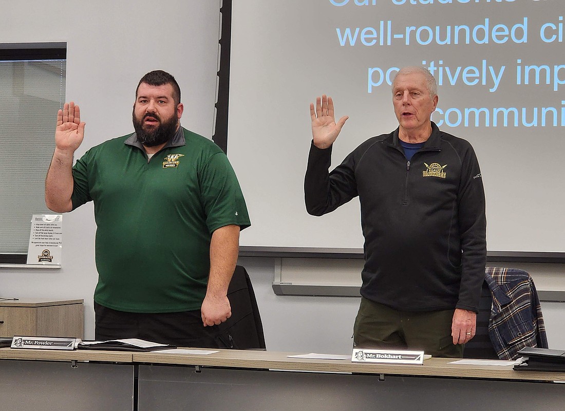 New Wawasee Community School Corporation Board of Trustees member Mike Fowler and re-elected board member Don Bokhart were given the oath of office during Tuesday’s meeting. Photo by Deb Patterson, InkFreeNews