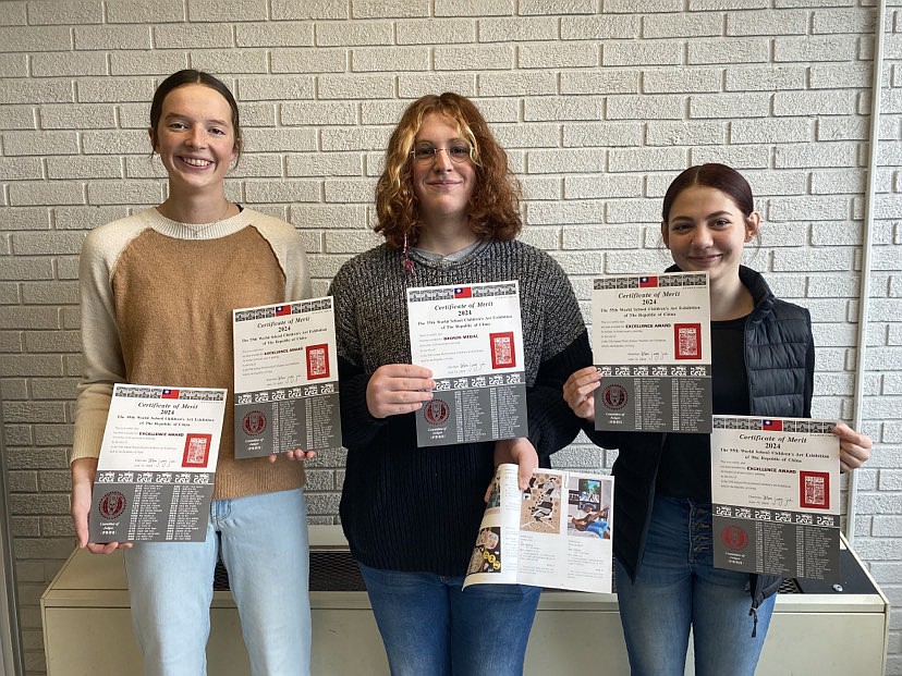 Three of five art students participating in and receiving awards from the World School Children’s Art Exhibition are (L to R) Ally Brown, Micah Slabach and Daelyn Kirkdorffer. Photo Provided