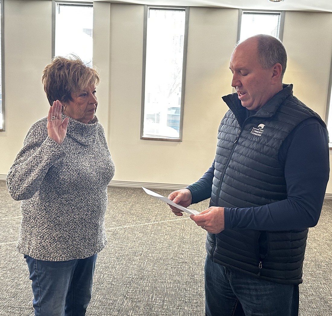 City of Warsaw attorney Scott Reust (R) gives the oath of office to Wayne Township Trustee Jeanie Stackhouse for the Warsaw-Wayne Township Fire Territory board on Friday at the Warsaw Board of Public Works and Safety meeting. Photo by David Slone, Times-Union