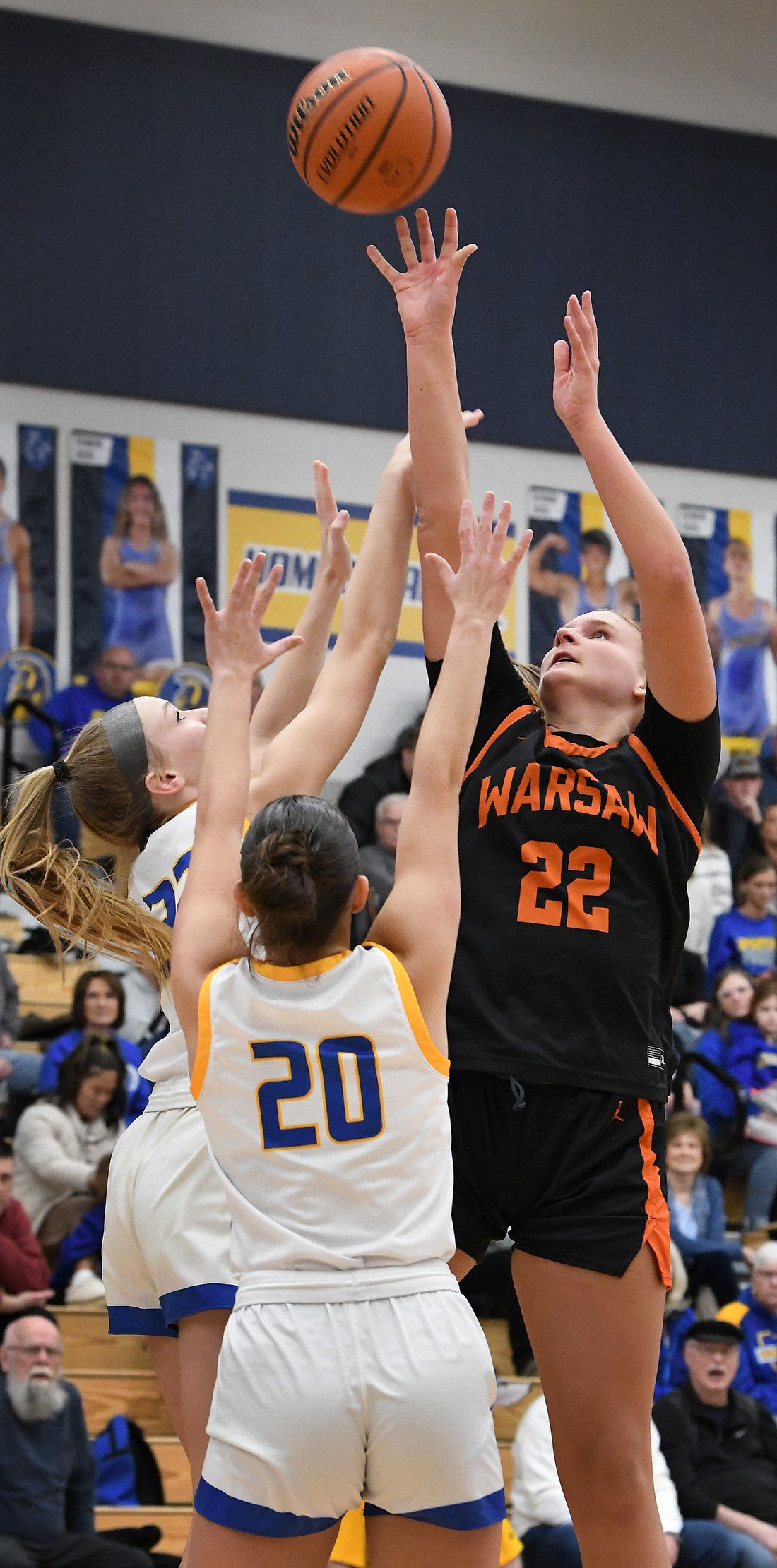 Warsaw senior Brooke Winchester scores over a pair of Homestead defenders during the second quarter...Nieter