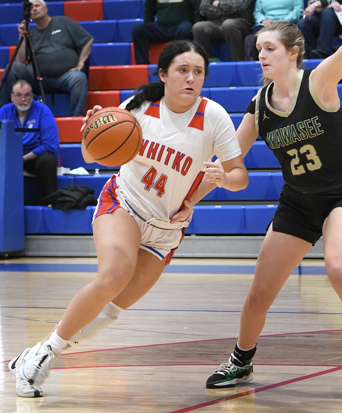 Whitko senior Adriyanna Phillips makes a quick move down the lane as Ava Couture of Wawasee defends...Nieter