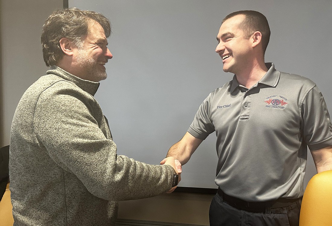 Warsaw-Wayne Fire Protection Territory Chief Joel Shilling (R) welcomes attorney Jack Birch (L) as the new legal representation for the territory after the board meeting Tuesday afternoon. Photo by David Slone, Times-Union