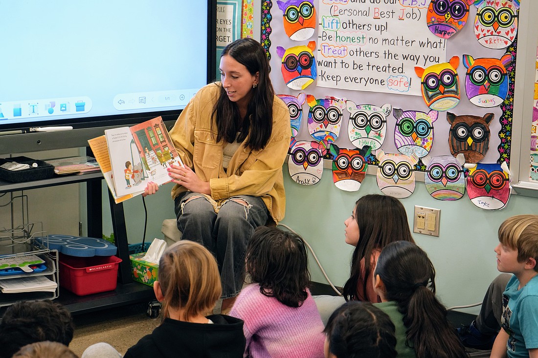 Warsaw Community High School junior Erin McManus reads to Julie Moore’s second-grade class.  Photo Provided.