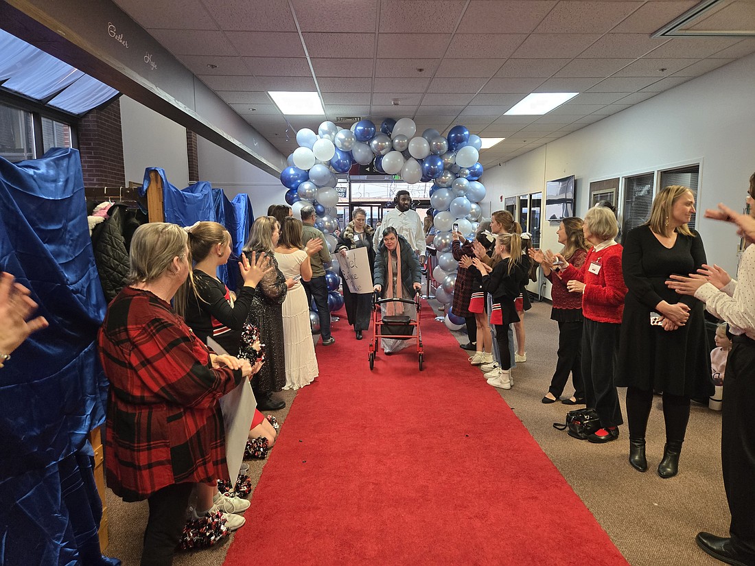 Guests and buddies are greeted at the “Night to Shine” event Friday at Warsaw Evangelical Presbyterian Church by a welcome squad. Photo by Jackie Gorski, Times-Union