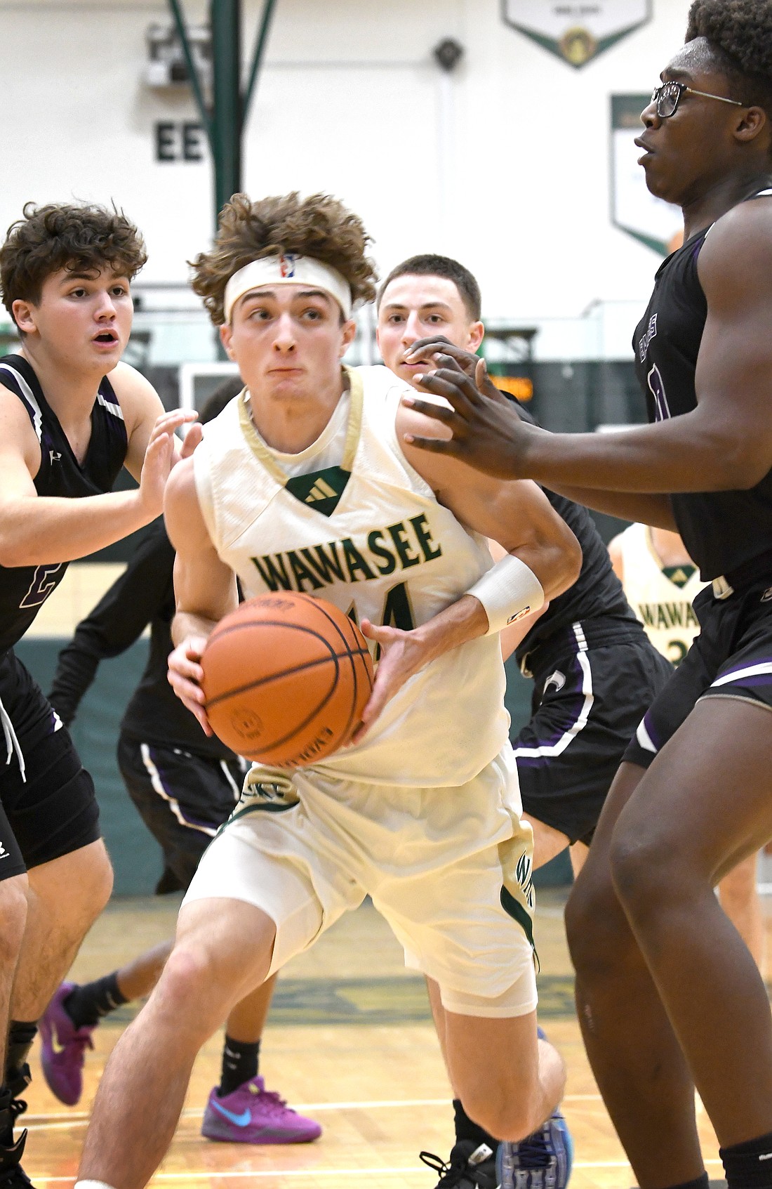 Surrounded by Elkhart Christian defenders, Wawasee junior Nolan Holzwart works his way down the lane toward the basket...Nieter