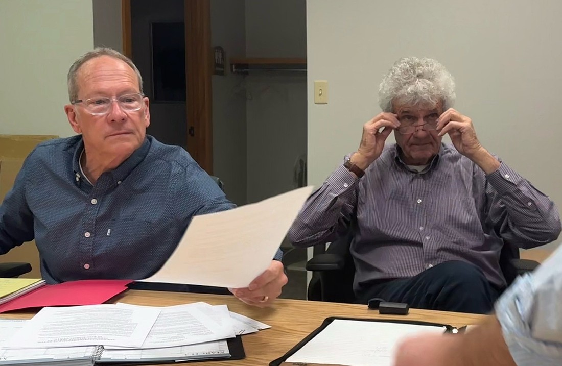 Mike Reed (L) and John Hall review documents at a Kosciusko County Public Defender Board meeting Thursday. Photo by Madison Hart, InkFreeNews