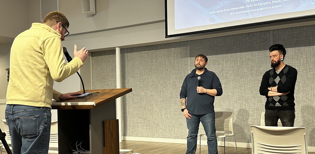 Former Kosciusko County Democrat Party Chair Brian Smith (L) brings up some legislative bills Saturday he thought people should know about as attorney Travis McConnell (C) and local business owner Nathan Underneath (R) listen. Photo by David Slone, Times-Union.