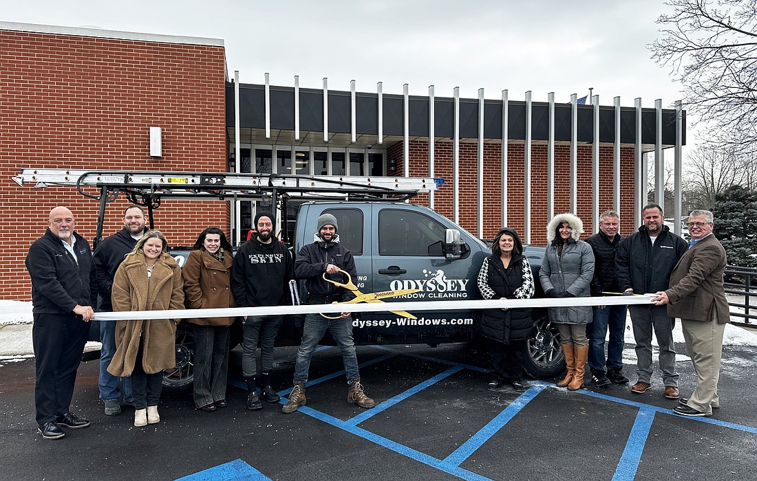 Kosciusko Chamber of Commerce staff and ambassadors had a ribbon-cutting ceremony Thursday for Odyssey Window Cleaning. Shane Jeffery (center with scissors), owner of Odyssey, cut the ribbon at the event. Photo by David Slone, Times-Union