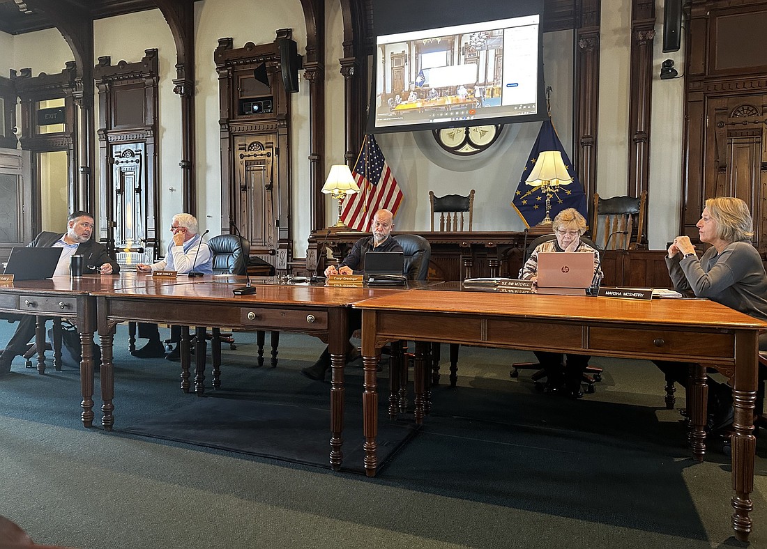 Kosciusko County Commissioners prepare for Tuesday morning’s meeting in the old courtroom of the county courthouse. Pictured (L to R) are county attorney Ed Ormsby; Commissioners Bob Conley, Cary Groninger, Sue Ann Mitchell; and county administrator Marsha McSherry. Photo by David Slone, Times-Union