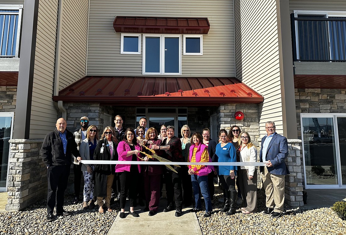 Tippe River Downs phase five is complete and apartments are available for leasing. To celebrate, the Kosciusko Chamber of Commerce held a ribbon-cutting ceremony for the new housing option Tuesday. Pictured are Chamber staff and ambassadors and representatives of Tippe River Downs. Photo by David Slone, Times-Union