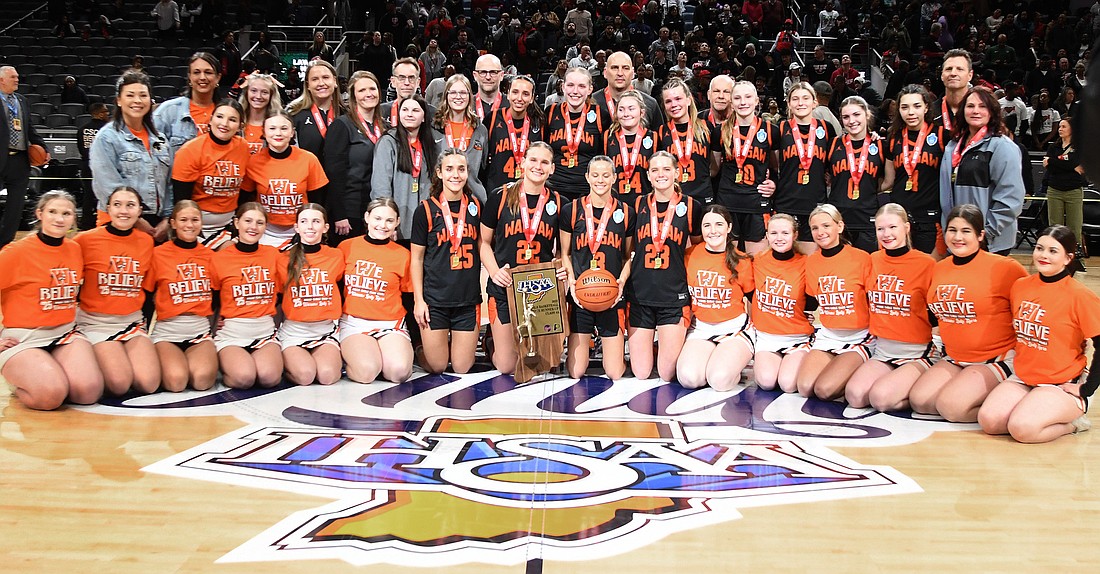 The Warsaw girls basketball team holds up it’s state runner-up trophy after falling to Lawrence North in the IHSAA 4A State championship game on Saturday night.