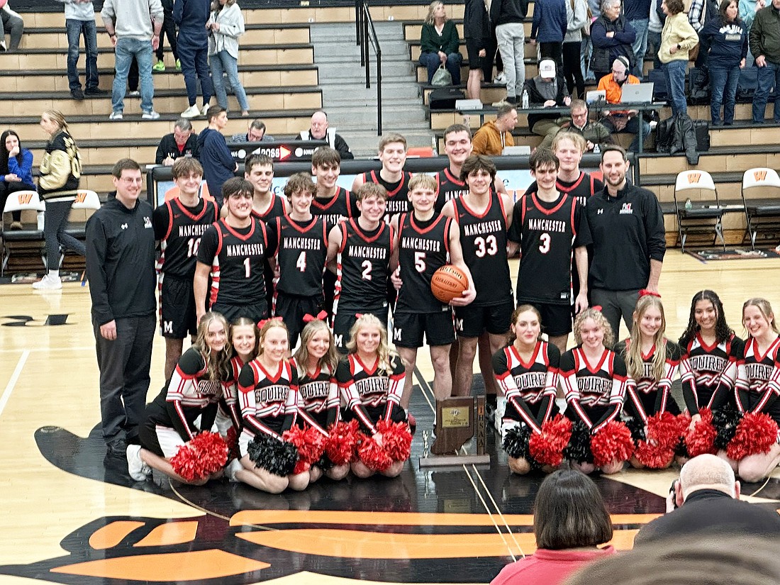 The Manchester basketball team celebrates after winning a sectional championship with a 70-38 victory over Oak Hill on Saturday.