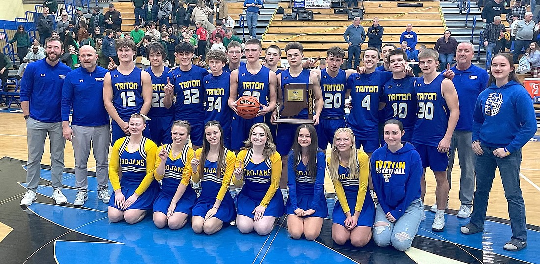 The Triton boys basketball team celebrates after winning a sectional championship at North Judson last weekend. Photo by Doug Griffiths, Pilot News