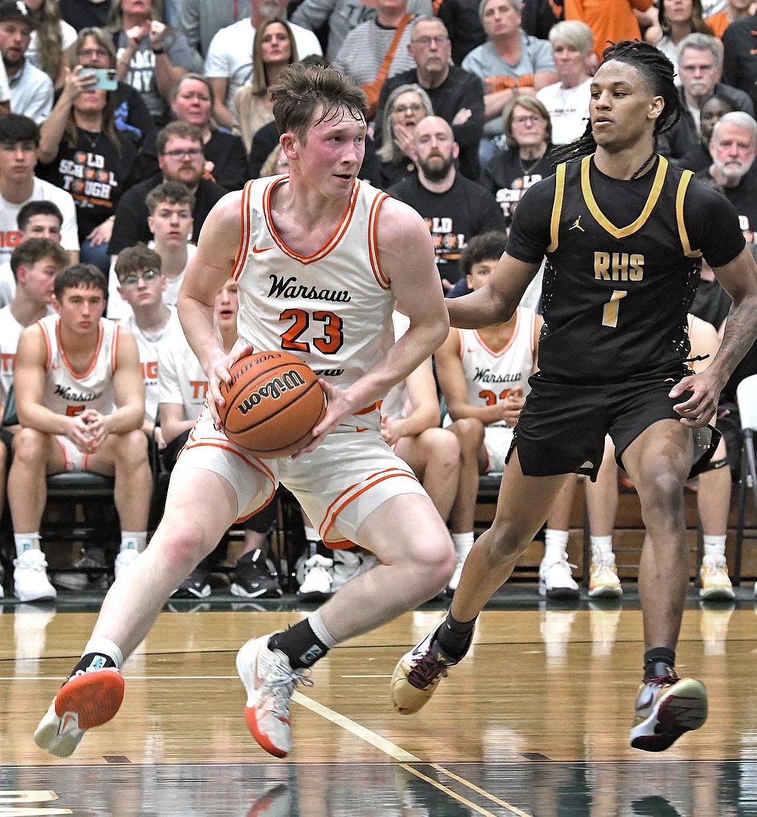 Warsaw senior Brandt Martin puts on the brakes while working his way across the lane during the third quarter...Nieter