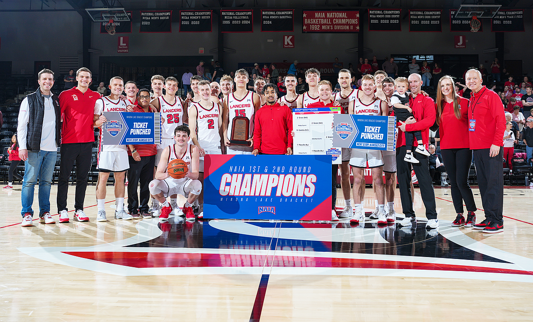 The Grace men’s basketball team celebrates after defeating Pikeville to advance to the Sweet 16 of the NAIA Tournament in Kansas City.