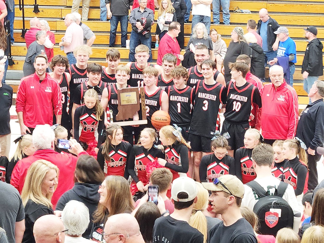 The Manchester basketball team gets set for some team photos as some of their fans hone in to take their shots.