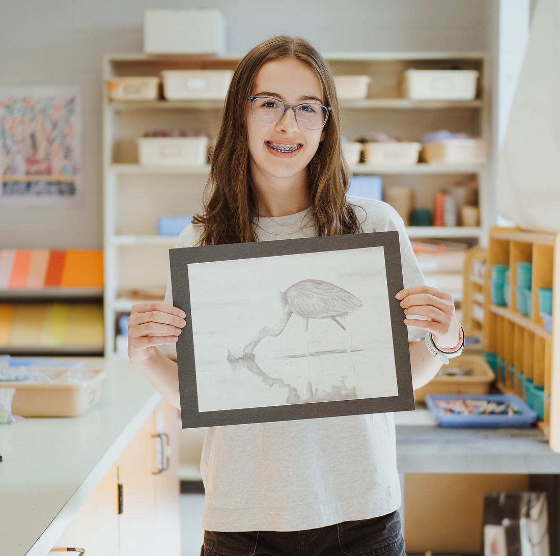 Estelle Jaumard holds her artwork, “Blue Heron.” Photo Provided