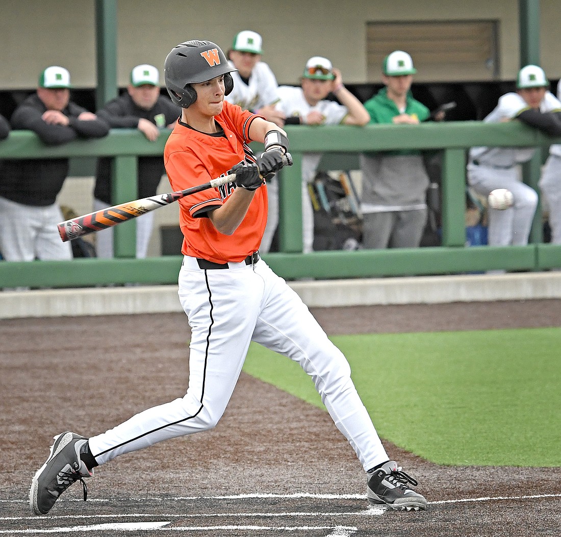 Freshman Rogan Bailey zeros in on the ball for a hit in the second inning to drive in Warsaw's first run of the game...Nieter
