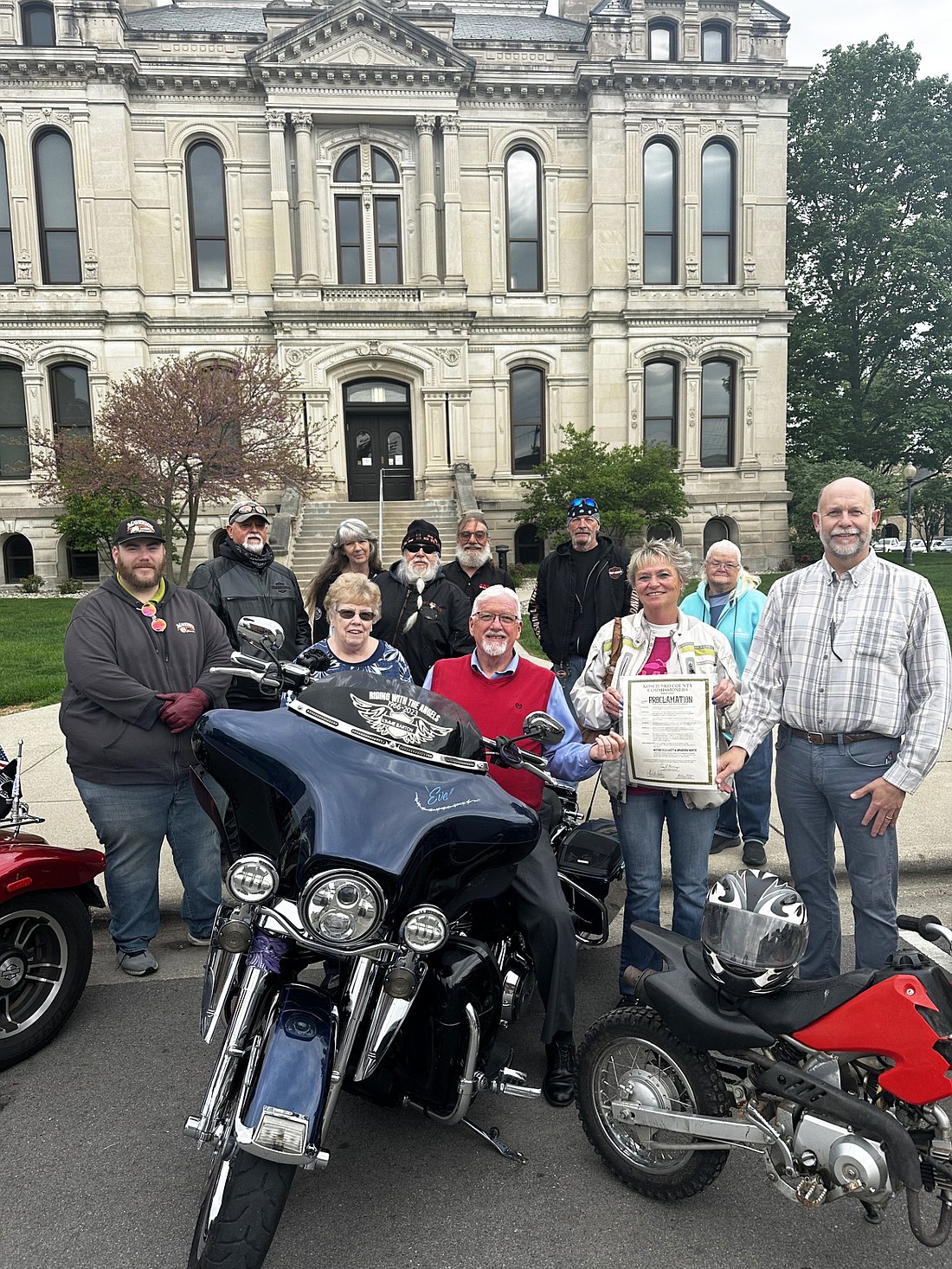 Kosciusko County Commissioners proclaimed May as Motorcycle Safety and Awareness Month Tuesday at the request of Region 1 American Bikers Aimed Toward Education (ABATE). Pictured (L to R) are, front row: Commissioners Sue Ann Mitchell and Bob Conley; Rhonday Hardy, ABATE; Commissioner Cary Groninger; back row: Keith Harris, Brian Mendenhall, Tony Howard, Kirby LeMond, Mike Dawson, all of ABATE; Donnie Barton, Region 1 ABATE county representative; and Sue Barton, ABATE. Photo by David Slone, Times-Union