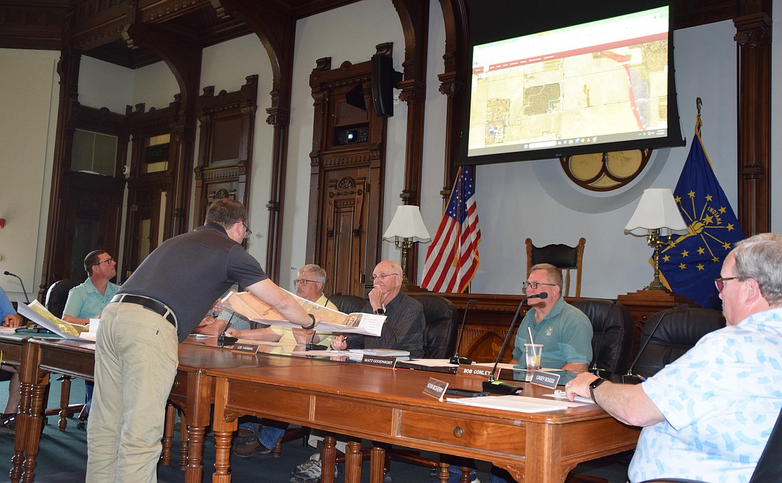 Matt Sandy (L), Kosciusko County Area Plan director, provides a map for Area Plan Commissioners to review. Seated (L to R) are Joe Irwin, Doug Ruch, James Moyer, Dr. Lee Harman, Matt Goodnight and Kevin McSherry. Photo by Lauren Zeugner, InkFreeNews