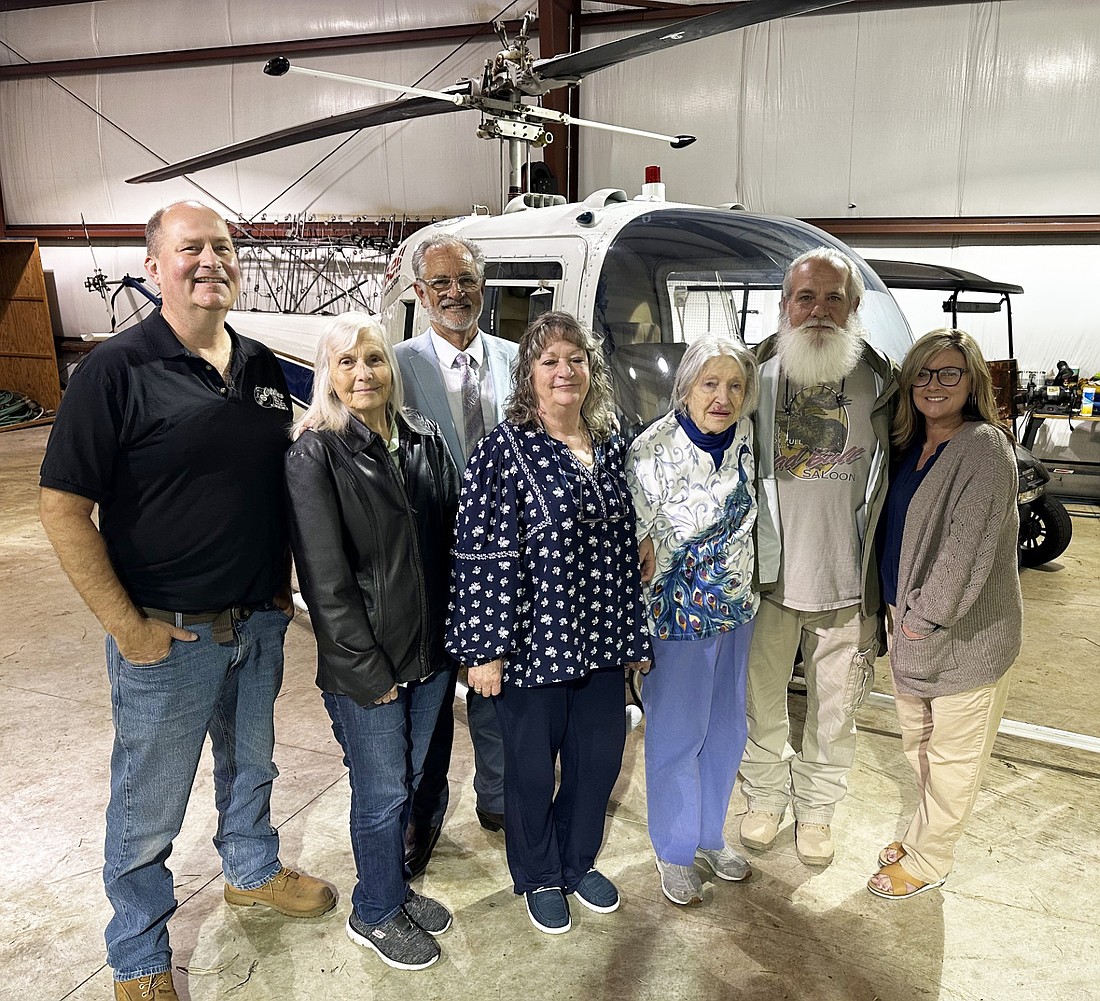 Dian Cartwright, 87, Warsaw, took her first-ever flight on a helicopter Thursday. She won the flight with Brian “Flyin’ Brian” Walsh after bidding on it at The Magical Meadows Rise Up fundraiser. Pictured (L to R) are Walsh, Elizabeth Adams, Carl Adams, Amy Goon, Cartwright, Tim Goon and Amy Beasley. Photo by David Slone, Times-Union