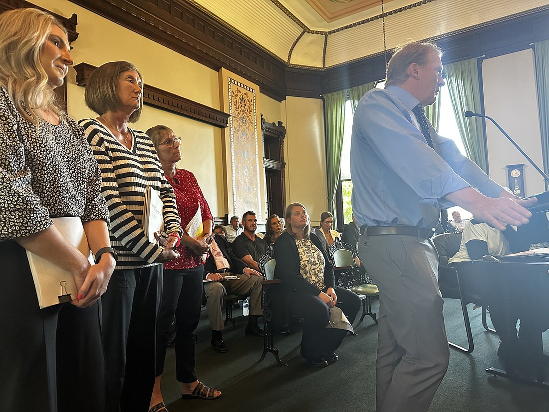 Superior Court II Judge Torrey Bauer (R) speaks about his support for wage increases for probation officers to the Kosciusko County Council Thursday night. Standing behind him are probation officers Kara Shively, Kelly Krugman and Tammy Johnston. Photo by David Slone, Times-Union