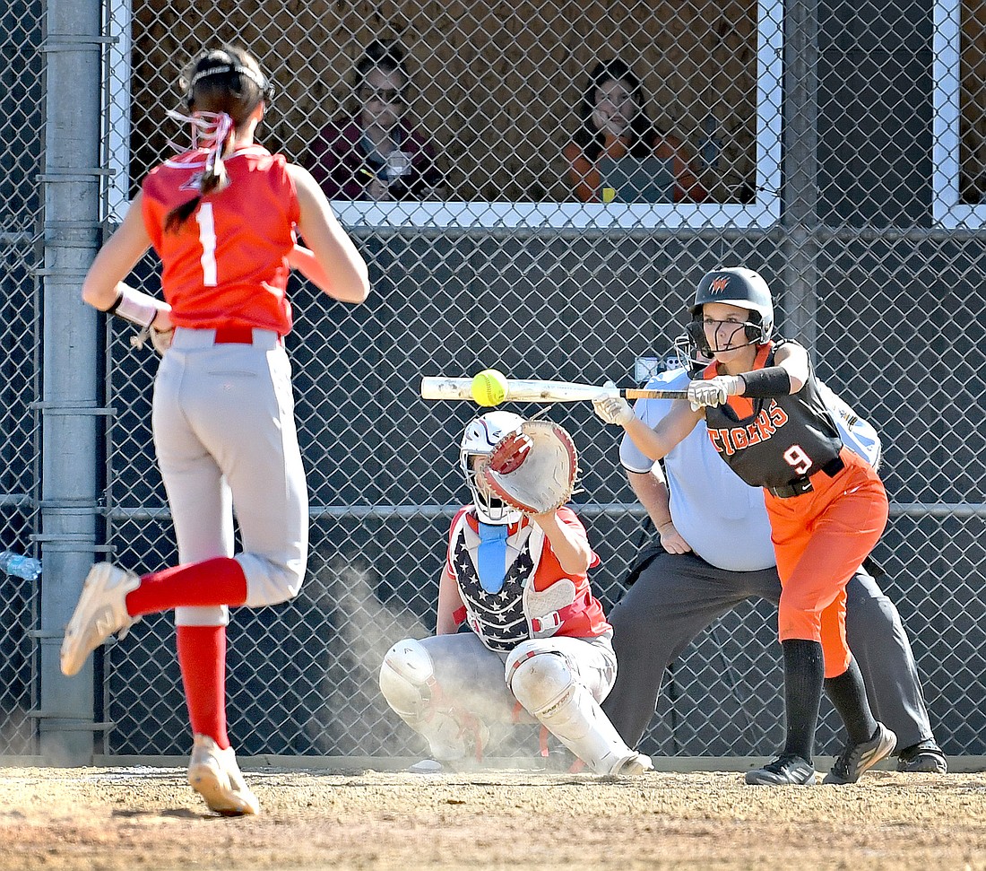 Warsaw senior Brooklyn Nibert lays down a bunt en route to reaching first base safely in the first inning of Friday evening's home game against Goshen...Nieter
