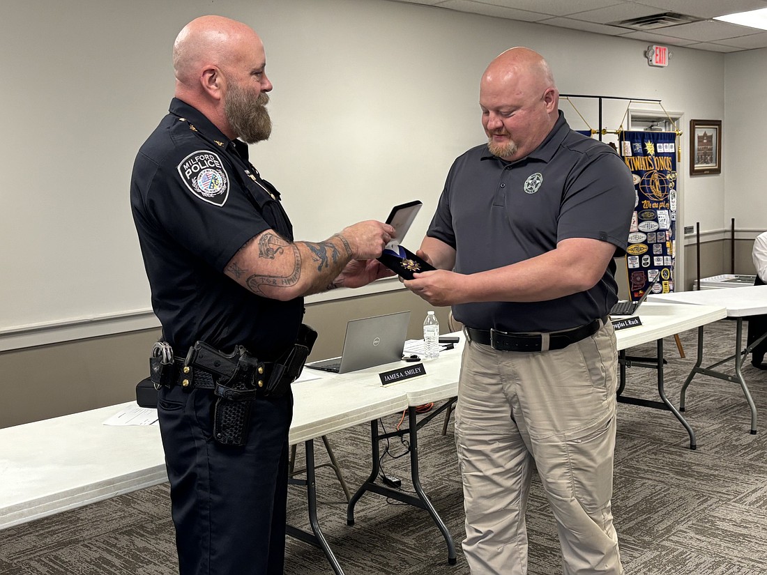 Town Marshal Thomas Waikel Jr. (L) presents a Distinguished Medal of Honor to former Town Marshal Derek Kreider for 30 years of service as he plans to retire May 20. Photo by Denise Fedorow
