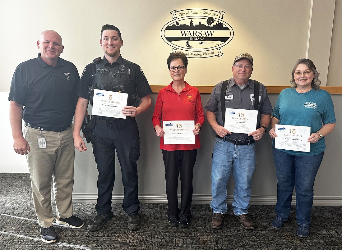 Five city employees were recognized Friday at the Warsaw Board of Public Works and Safety for their service anniversaries in May. Pictured (L to R) with Mayor Jeff Grose are Warsaw Police Department officer Mason Metzinger, five years; Lynne Lafollette, WPD, 15 years; Greg Weber, Warsaw Wastewater Treatment Utility, 15 years; and Leigh Ann Denlinger, Oakwood Cemetery, 15 years. Not pictured is Paige Wood, WPD, five years. Photo by David Slone, Times-Union