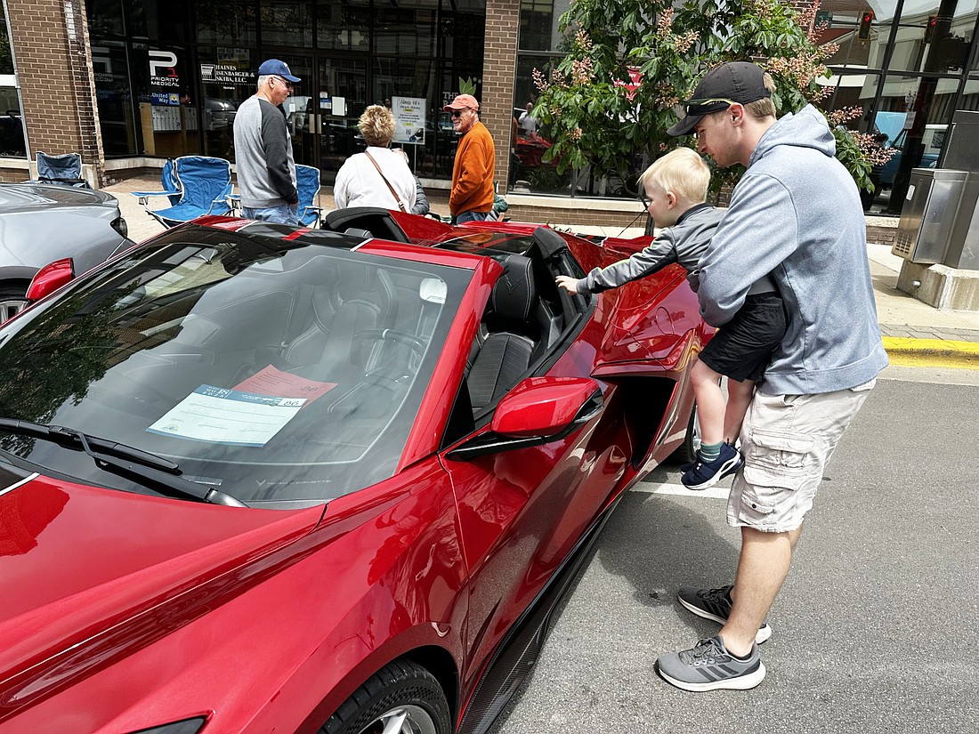 Nick and Preston Feldman, Warsaw, admire a 2025 Corvette, owned by Jim and Deb Lotz, Warsaw, during Sunday’s Warsaw Breakfast Optimist Club 15th Annual Car Show downtown Warsaw. Photo by David Slone, Times-Union