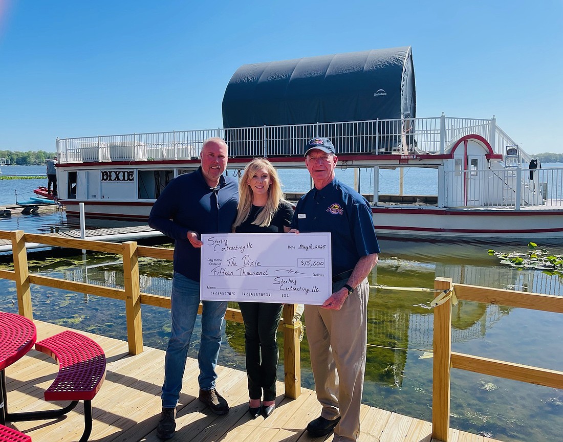 (L to R) Sterling Contracting owners Jeremy and Tiffany Makinson present a donation to Bob Dailey for The Dixie. Photo Provided